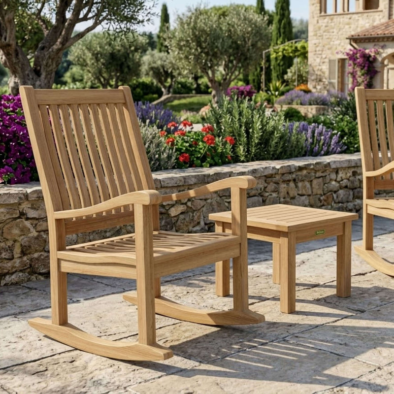 Del-Amo roching armchair and the bahama mini side table in front of a stone wall with flowers.  