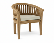 Anderson teak curved dining arm chair with dupione sand cushion on white background. 