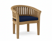 Anderson teak curved dining armchair with navy cushion on white background. 