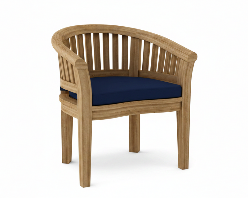 Anderson teak curved dining armchair with navy cushion on white background. 