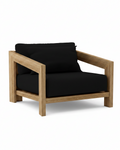 Smyrna teak lounge chair with black cushion on white background.  