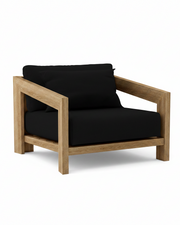 Smyrna teak lounge chair with black cushion on white background.  