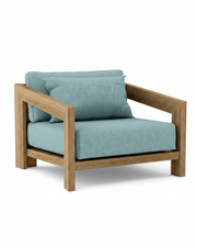 Smyrna teak lounge chair with mineral blue cushion on white background.  