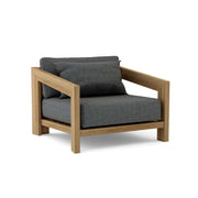 Smyrna teak lounge chair with cast charcoal cushion on white background.  