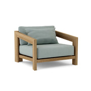 Smyrna teak lounge chair with cast mist cushion on white background.  