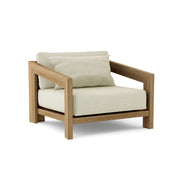 Smyrna teak lounge chair with natural cushion on white background.  