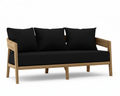 Toscana teak sofa with black cushions on a white background.