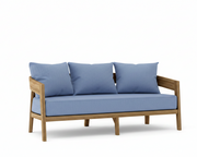 Toscana teak sofa with ocean blue cushions on a white background.