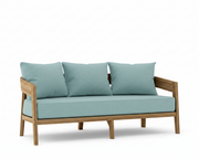 Toscana teak sofa with mineral blue cushions on a white background.