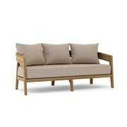 Toscana teak sofa with cast ash cushions on a white background.