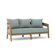 Toscana teak sofa with cast mist cushions on a white background.