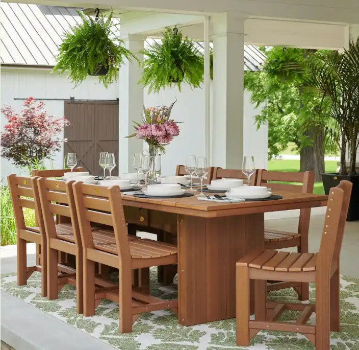 Urban dining table 3 x 8 rectangular on a concrete patio near a barn.  