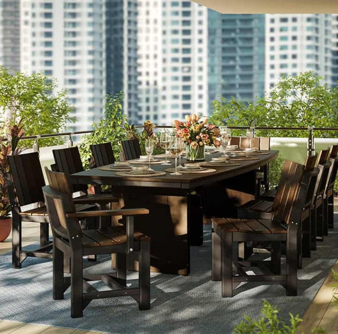 An outdoor dining set on a balcony, featuring a rectangular dark table surrounded by matching armchairs and a floral arrangement in the center.